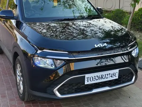 Black Kia Carens cab in Vrindavan